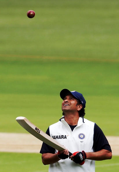 Sachin Tendulkar bounces a ball on his bat during a practice session.