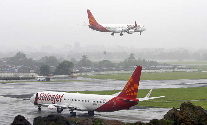 SpiceJet aircraft prepare for landing and take-off in Mumbai.