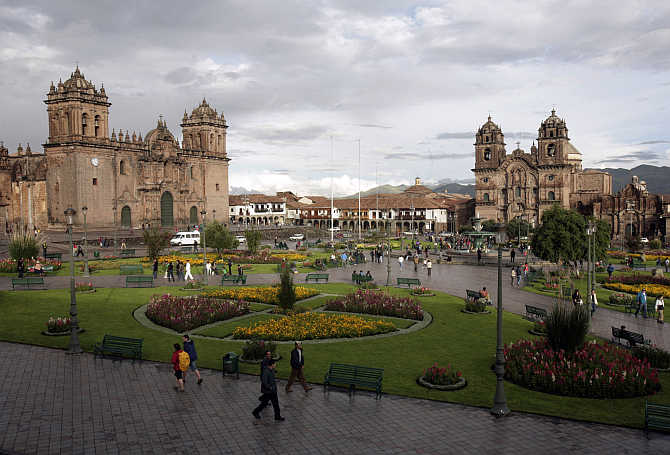 People walk in the main plaza in Cuzco, Peru.