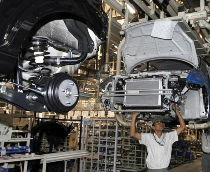 Workers assemble a car at a Maruti Suzuki plant in Manesar.