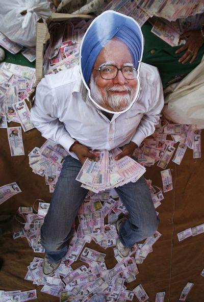 An activist from the India's main opposition Bharatiya Janata Party (BJP), wears a mask depicting Prime Minister Manmohan Singh, during an anti-government protest in New Delhi.