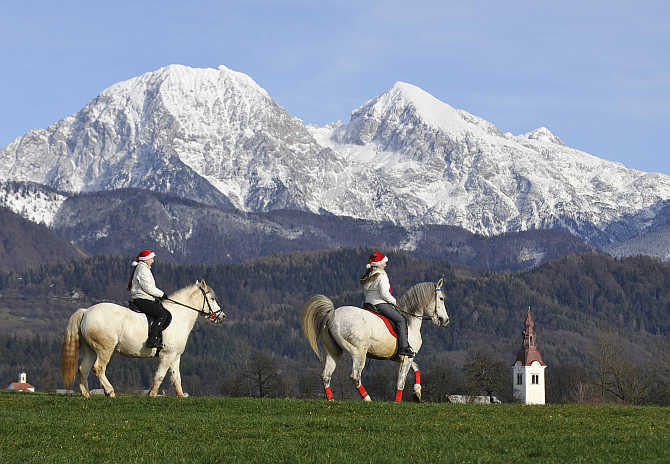Girls make their way to church for their horses to be blessed by priests on St Stephens day in Srednja Vas, Slovenia.