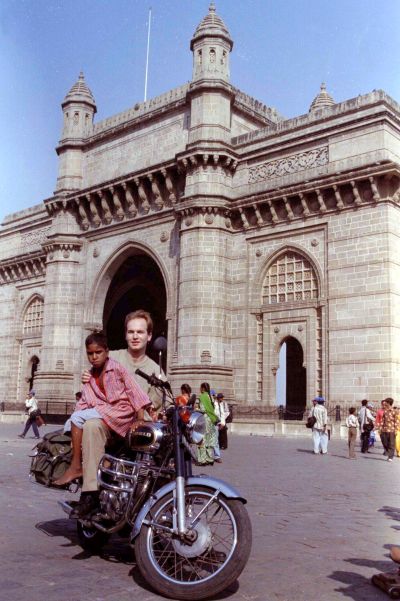 Frenchman Yannick Ollivier poses with Giri Gopal, a street child in front of the Gateway of India in Mumbai.