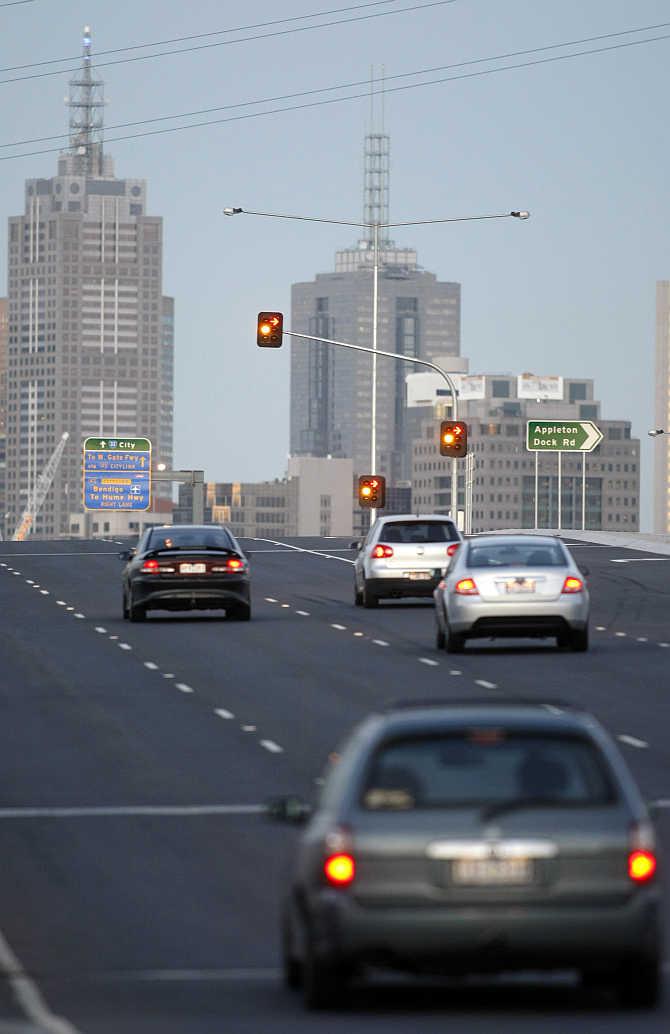 Cars drive over a bridge towards central Melbourne, Australia.