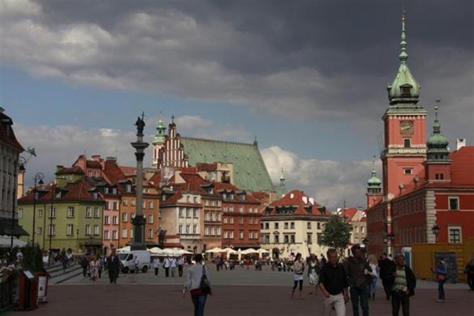 People walk at Plac Zamkowy in Warsaw's Old Town.