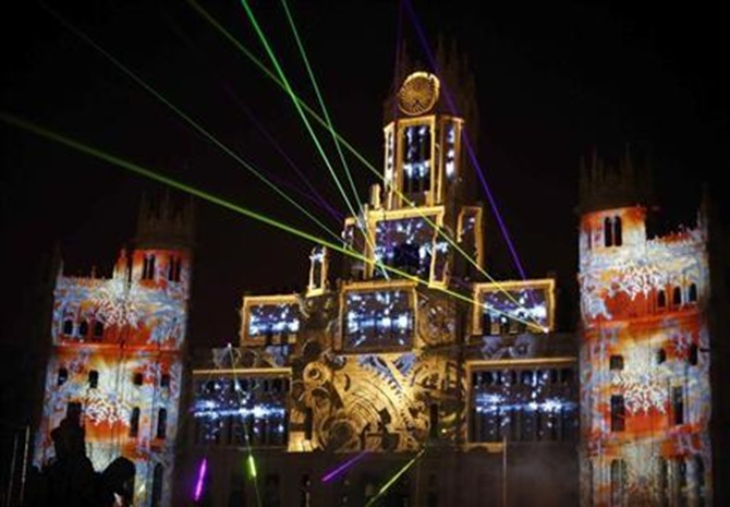 Laser beams and images are projected on the facade of Madrid's city hall during a light show in Madrid.