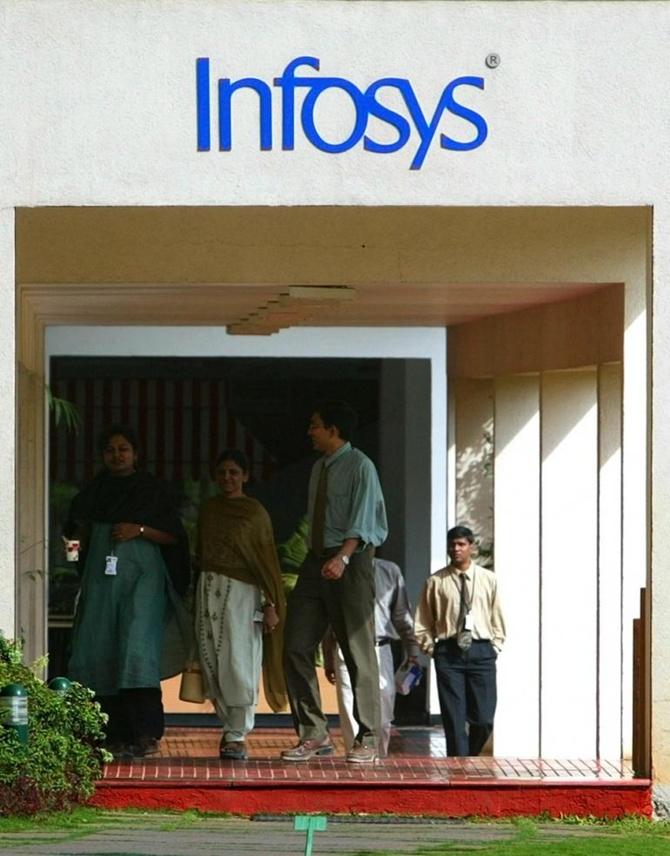 Staff walk in Infosys Technologies campus at Electronics City in Bangalore.