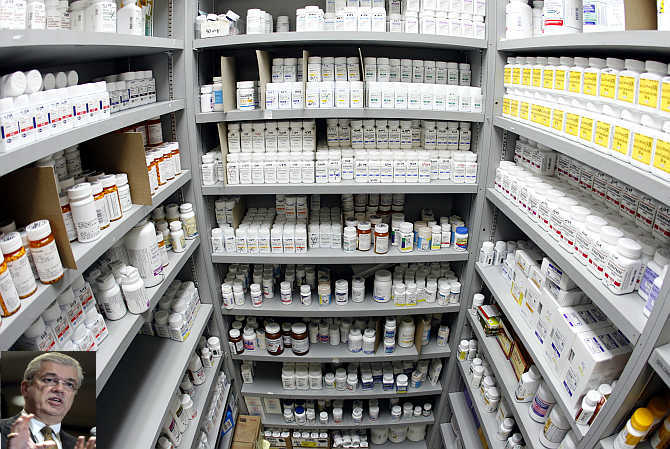 Pills line the shelves in the pharmacy at Venice Family Clinic in Los Angeles. Inset, William McGuire.