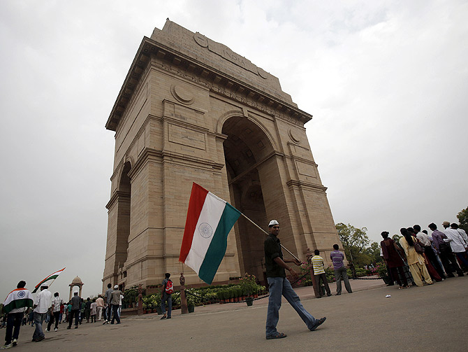 A supporter of veteran Indian social activist Anna Hazare holds India's national flag at the India Gate during a hunger strike by Hazare and his team members in New Delhi.