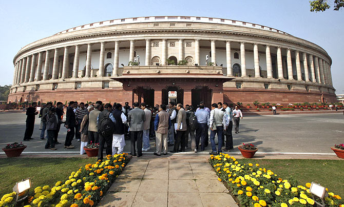 People stand in front of the Indian parliament building on the opening day of the winter session in New Delhi in November 2012.