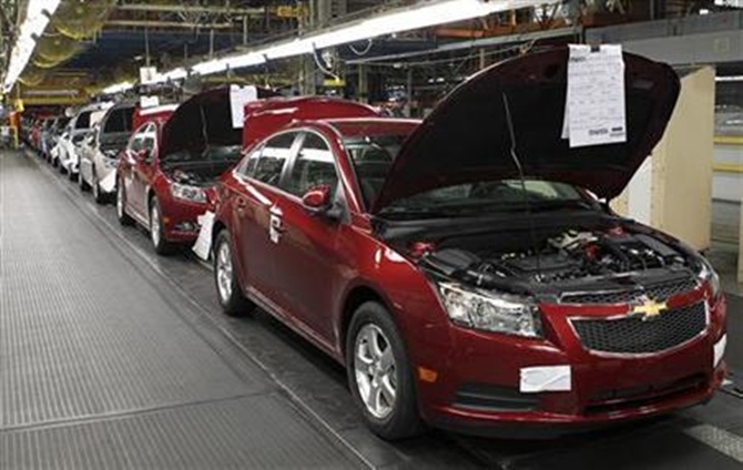 Fully assembled Chevrolet Cruze cars reach the end of the assembly line at the General Motors Cruze assembly plant in Lordstown, Ohio.