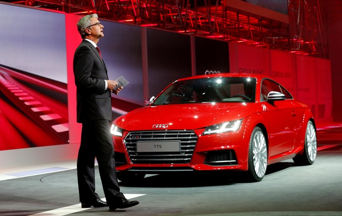 Audi's CEO Rupert Stadler speaks next to an Audi TTS during a Volkswagen Group Night event ahead of the 84th Geneva Motor Show in Geneva late March 3, 2014.
