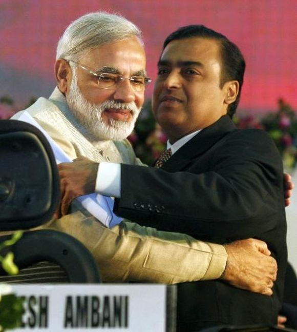 Gujarat's chief minister Narendra Modi (L) embraces Mukesh Ambani, chairman of Indian energy company Reliance Industries.