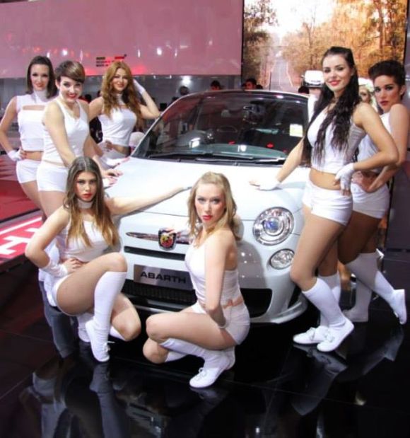 Models surround Fiat Abarth 500 at the Indian Auto Expo.