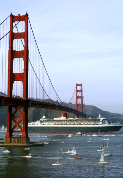 The Queen Mary 2 sails beneath the Golden Gate Bridge as it enters the harbor in San Francisco, California.