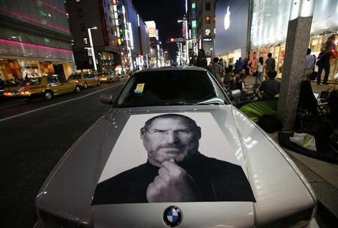 A portrait of Apple co-founder Steve Jobs is seen on a BMW car in Tokyo.