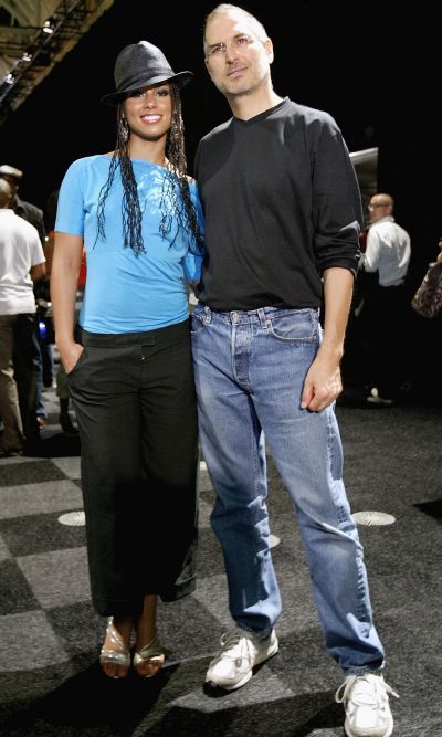 Steve Jobs posing for a photo with R&B singer Alicia Keys during launch of iTunes Music Store.