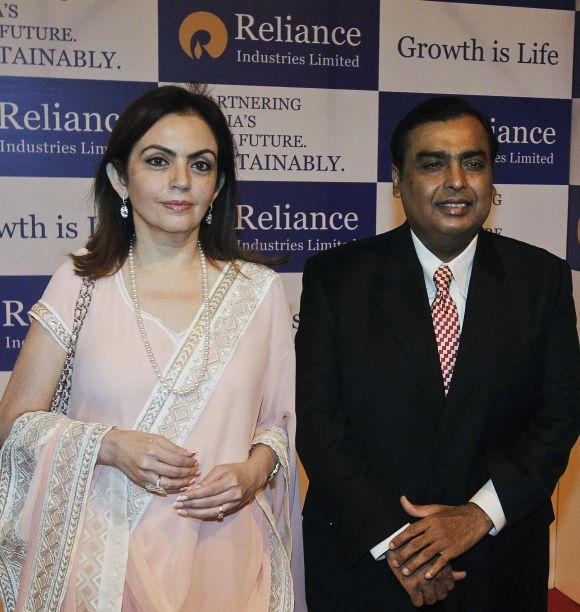 Reliance Industries' Chairman Mukesh Ambani (R) poses with his wife Nita Ambani before addressing the company's annual general meeting in Mumbai.