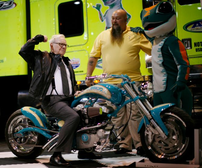 Billionaire financier and Berkshire Hathaway Chief Executive Warren Buffett poses on a motorcycle during the Berkshire Hathaway Annual Shareholders meeting in Omaha.