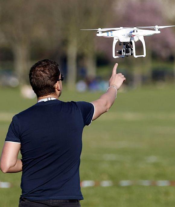 A pilot flies a drone.