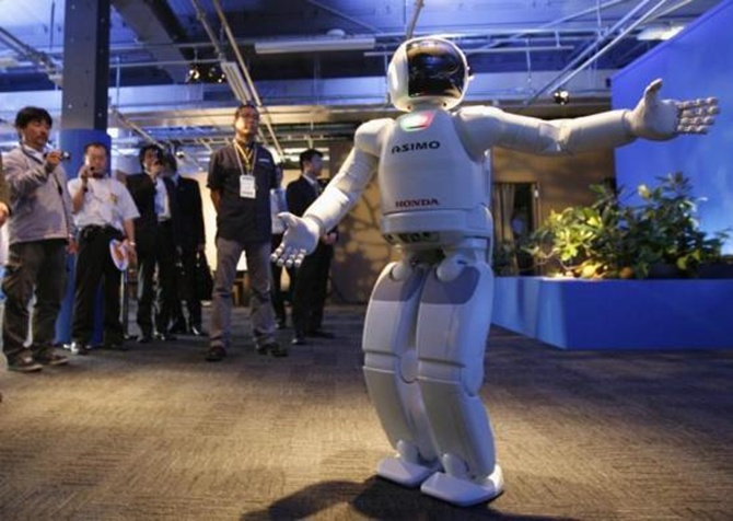 Asimo makes introductions at an exhibition pavilion inside the media center for G8 Hokkaido Toyako Summit.