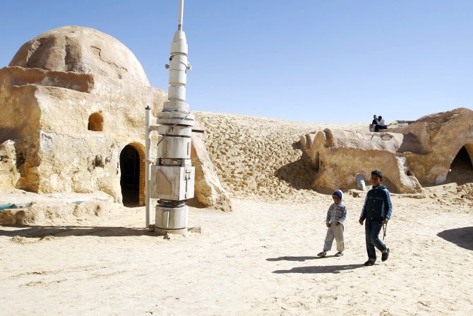 Local boys sell traditional souvenirs in the Star Wars movie set in the Ong Jmal, in Nefta, southern Tunisia.