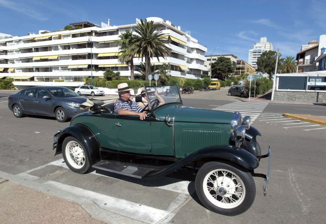 A man drives his 1935 Ford A through the streets of the luxurious seaside resort of Punta del Este.