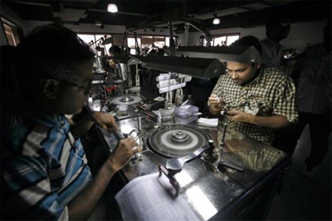 Employees work inside the polishing department of a diamond processing unit at Surat.