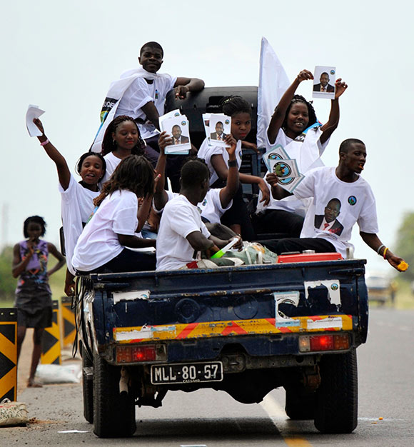 Supporters of the opposition MDM party wave placards while travelling in a vehicle in the capital Maputo.