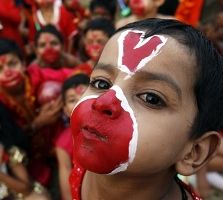 Image: Boys with their faces painted before a play reenacting a scene from the Ramayana. Photograph: Ajay Verma/Reuters