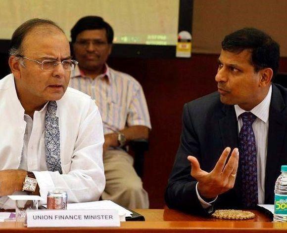 India's new Finance Minister and Defence Minister Arun Jaitley (L) listens to Reserve Bank of India (RBI) Governor Raghuram Rajan during a financial stability development council meeting.