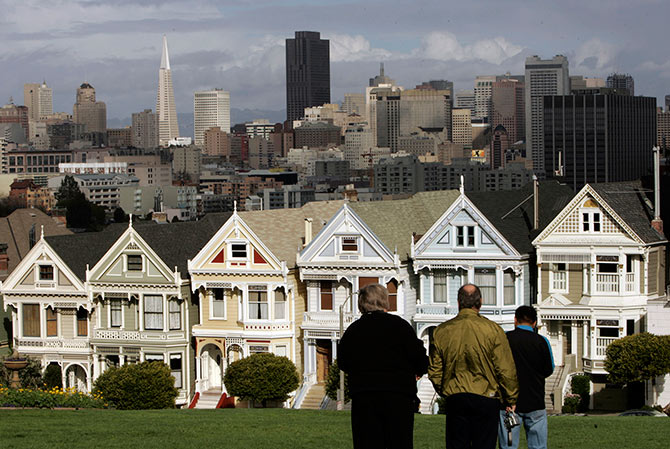 Tourists take in the view of the skyline including its Victorian homes known as thePainted Ladies in San Francisco.