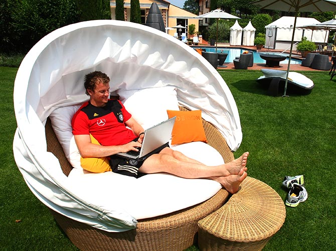 Jens Lehmann sits in the garden of a hotel.