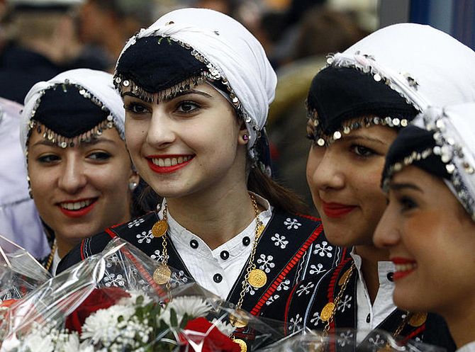 Women dressed in traditional Turkish dresses await the arrival of a train from Istanbul celebrating the 50th anniversary of Turkish migrant workers agreement between Turkey and Germany in Munich.