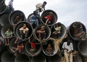 Image: Children play in water pipes at a construction site on the banks of the Yamuna River in Allahabad. Photograph: Jitendra Prakash/Reuters