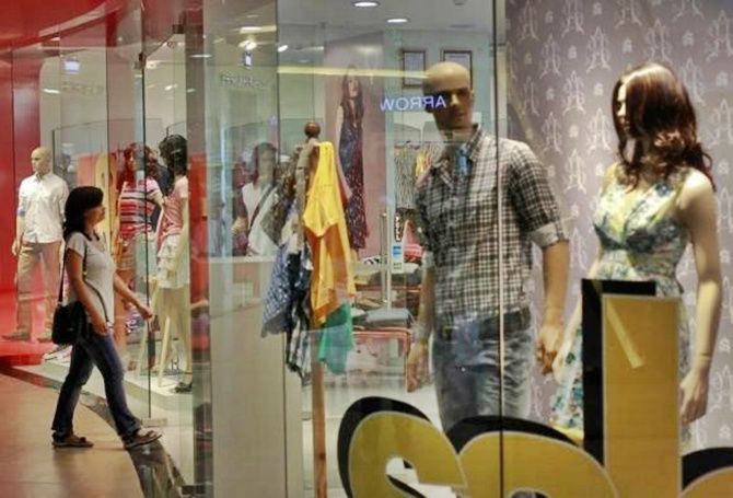 A woman enters a retail store inside a shopping mall in Mumbai.