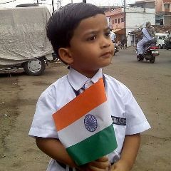 A boy holds a national flag