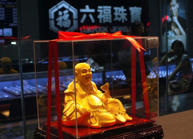 A gold Buddha statuette is seen inside a Luk Fook Jewellery shop in Yichang, Hubei province.