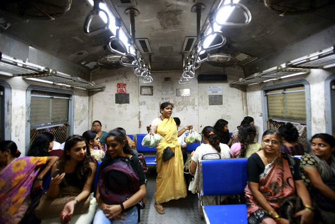 A vendor sells vegetables inside the Ladies' Special train in Mumbai