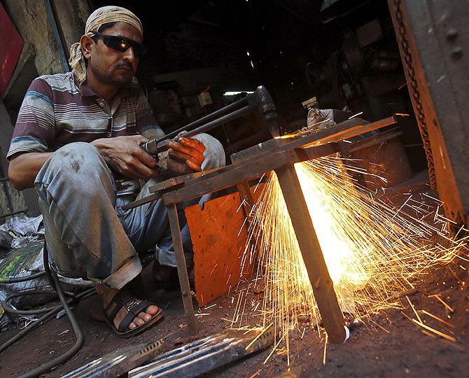 A labourer works outside an aluminium smelting factory in Mumbai.