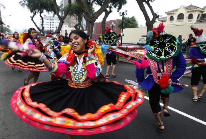 A girl dances during a protest in Lima to demand that the G8 countries comply with their commitment to increase aid to the poorest nations.