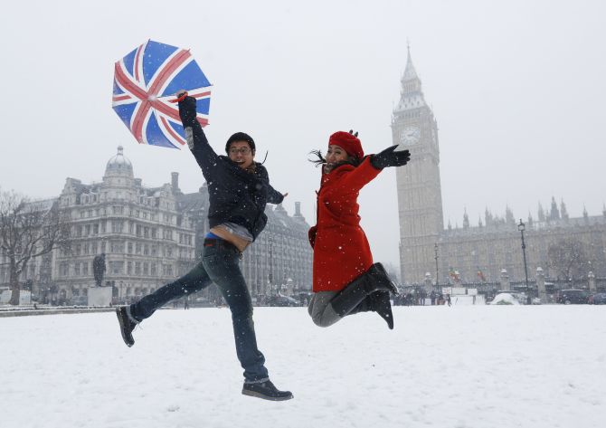 Pandu and Dian, tourists from Indonesia, jump for a souvenir photograph.