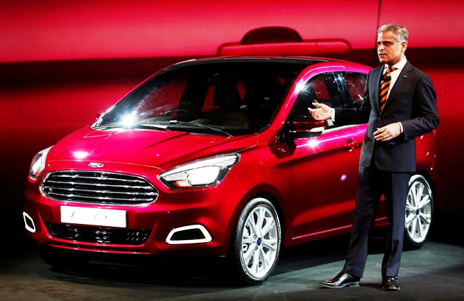 Kumar Galhotra, Vice-President, Engineering, Ford Motor Co, stands next to a Ford Figo global compact concept car at a press preview in New Delhi February 3, 2014.