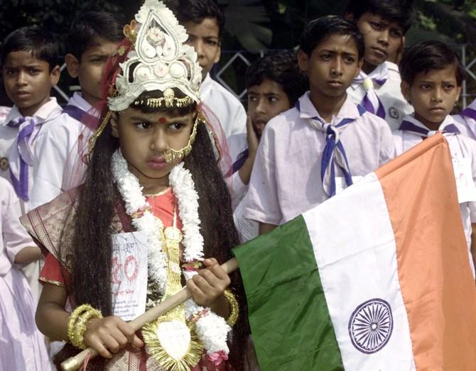 A school girl holds the Indian tricolour aloft at a rally in Kolkata.