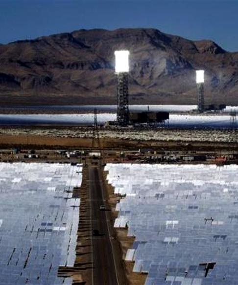 Heliostats reflect sunlight onto boilers in towers during the grand opening of the Ivanpah Solar Electric Generating System in the Mojave Desert near the California-Nevada border.