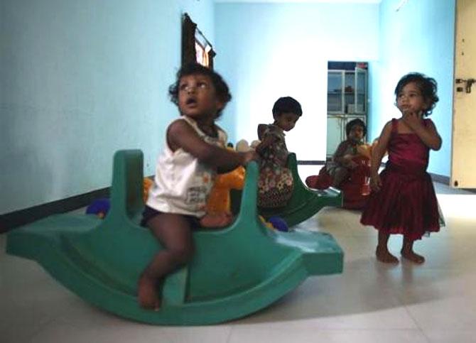 Baby girls play inside the Life Line Trust orphanage in Salem, Tamil Nadu.