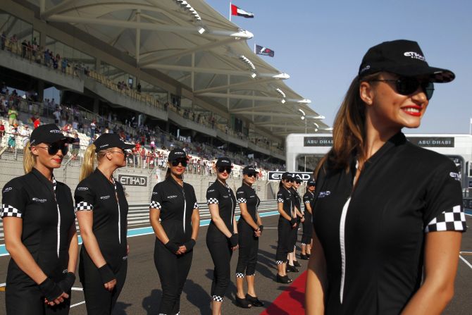 Grid girls pose before the Abu Dhabi F1 Grand Prix at the Yas Marina circuit on Yas Island.