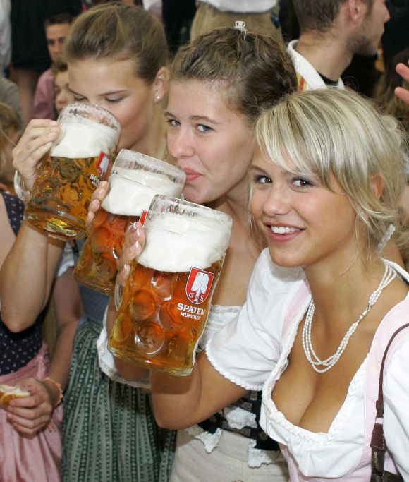 Girls in traditional Bavarian clothes toast with one-litre beer mugs during the opening day of the Oktoberfest in Munich.