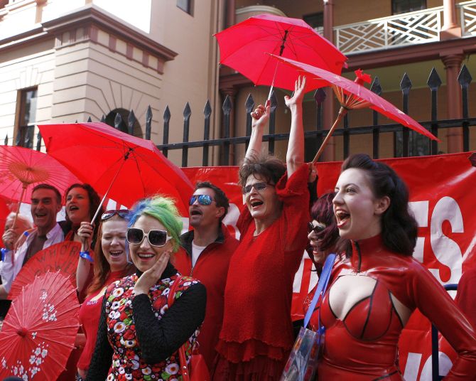 Sex workers shout slogans during International Whores Day in central Sydney.