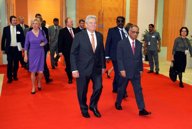 German President Joachim Gauck (C) arrives with Infosys Executive Chairman and co-founder NR Narayana Murthy to address an Indo-German conference at Infosys headquarters in Bengaluru.